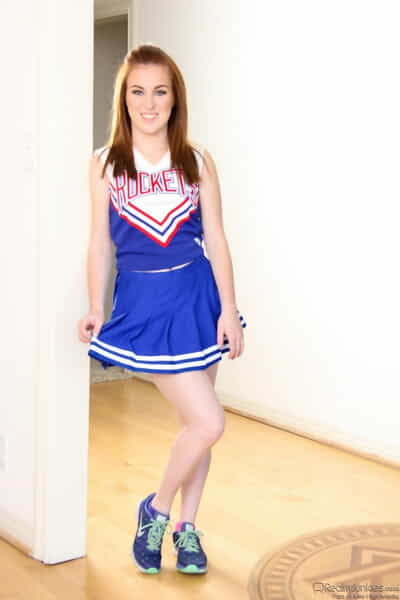Cute redhead cheerleader Jessie Parker happily spreading her tight ass
