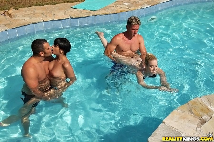 Coco Demal and her friend Nesty swimming with a handsome fellow